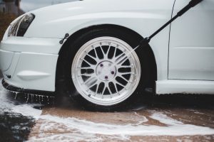 Photo by Erik Mclean white car with black wheel